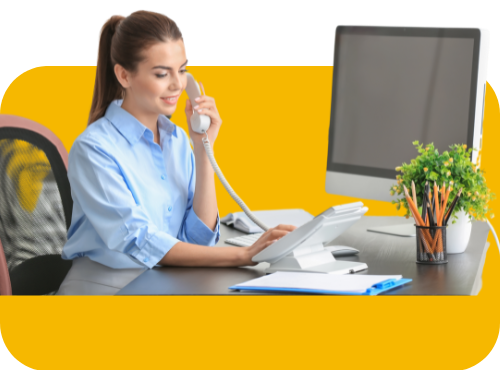 Young female receptionist at a desk on the phone